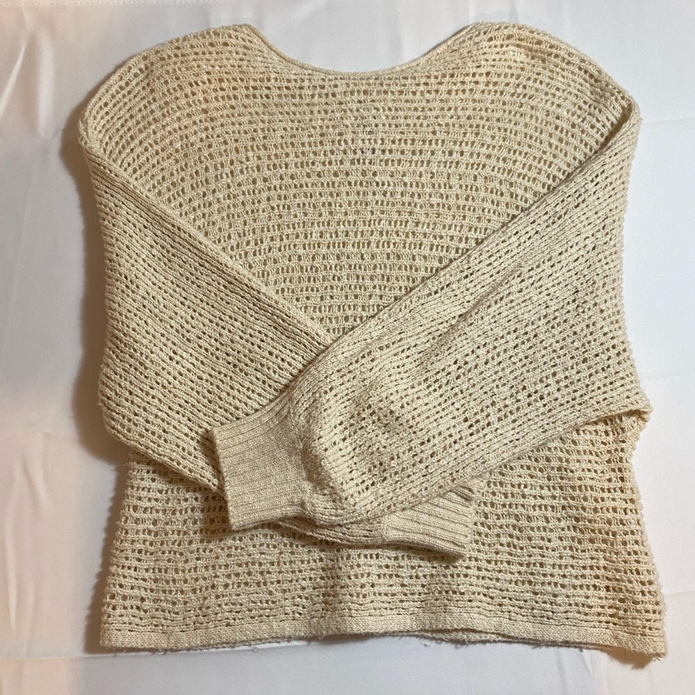 Cream colored, long sleeved knit cover up 

Brand: Billa Bong